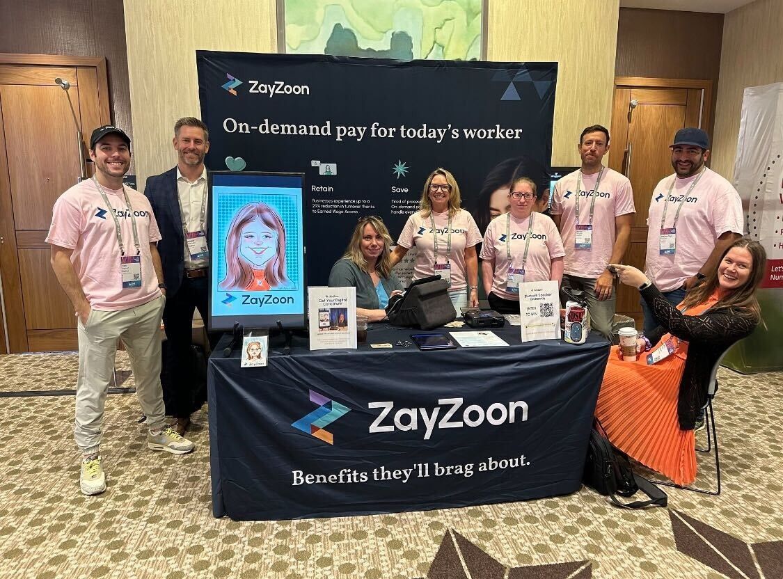Caricature artist at ZayZoons booth during PrismHR Live
